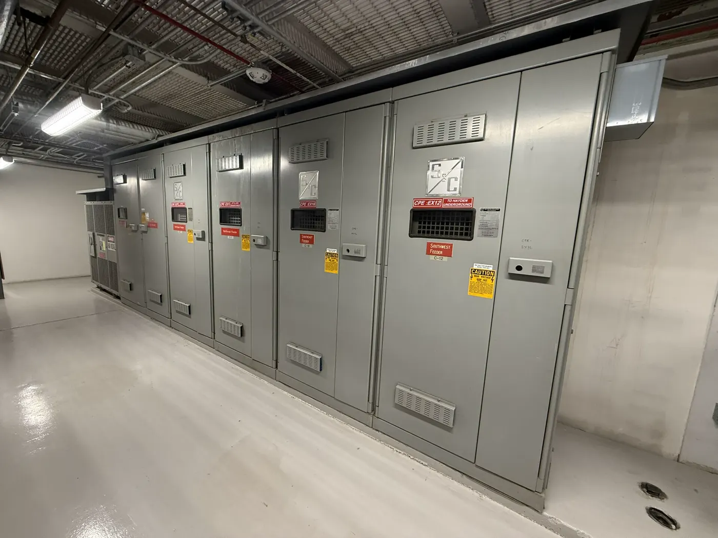 Metal-clad switchgear lineup in an electrical room — representative photo