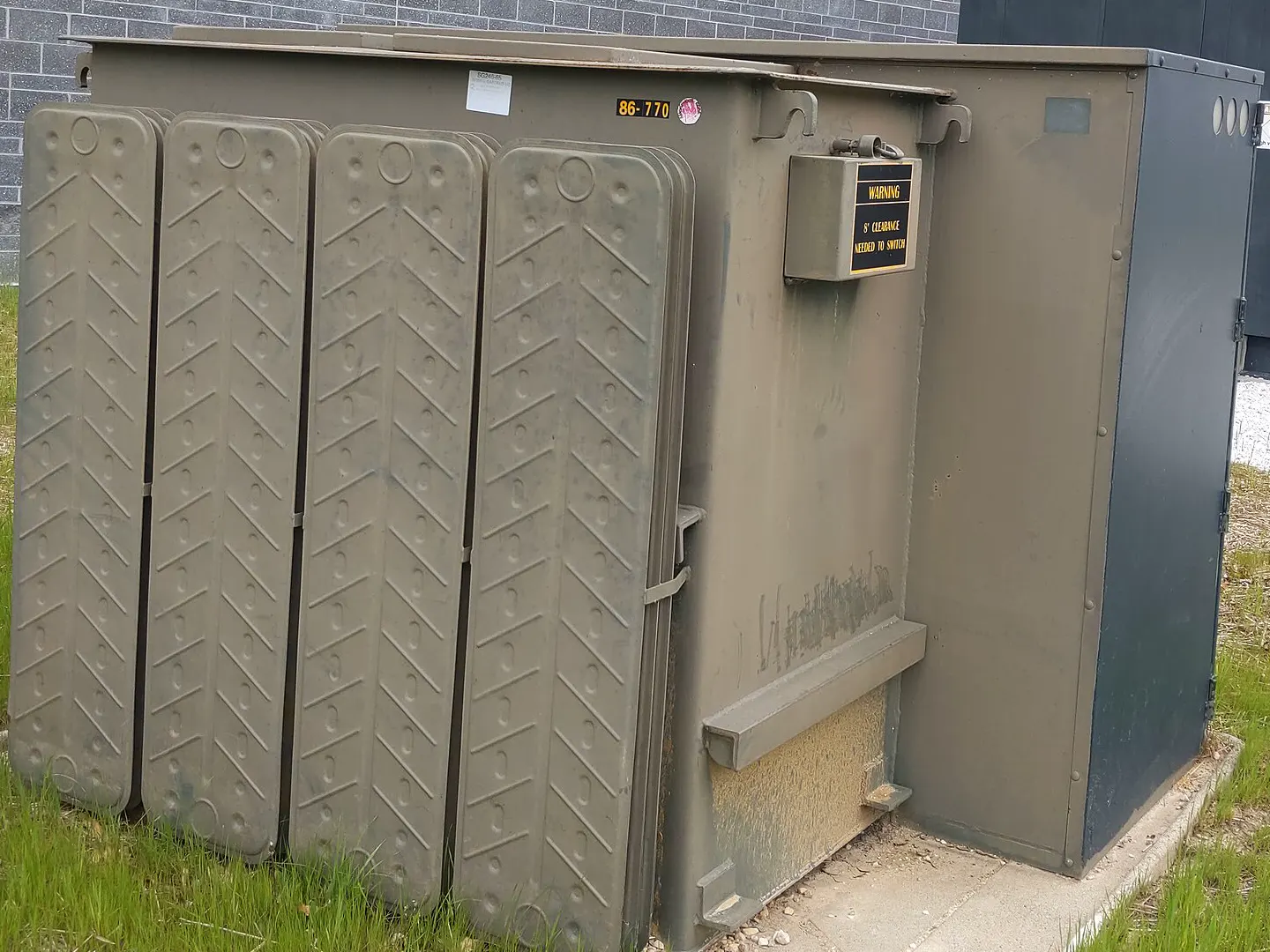 Reconditioned 1000 kVA pad-mount transformer, corrugated cooling fins visible — representative photo